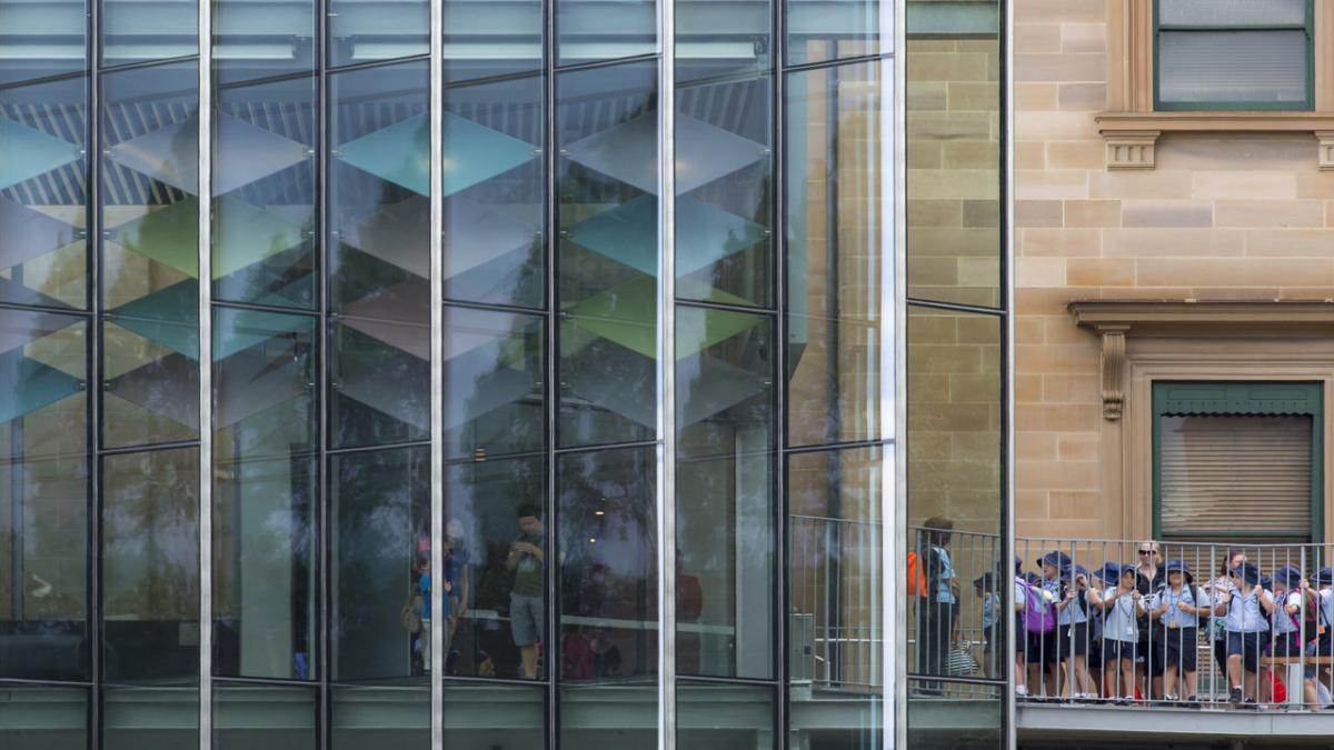 glass building, line of students