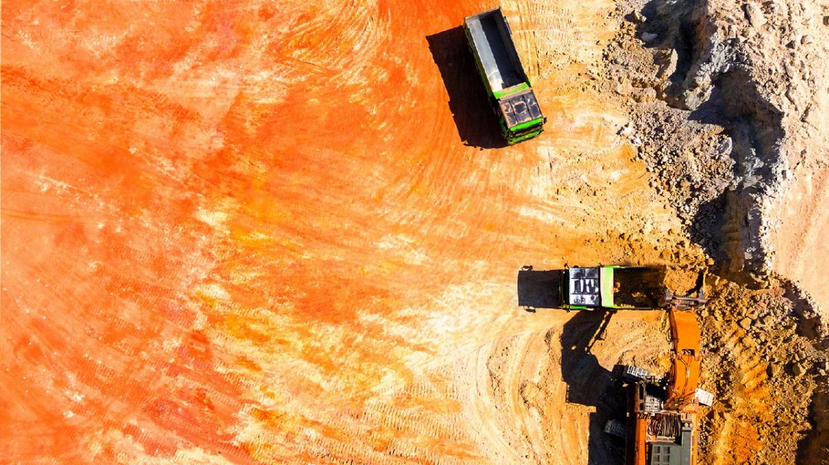 ariel view of red mining landscape with trucks