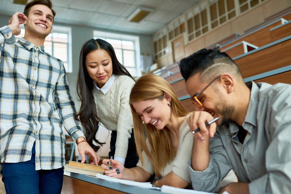 group shot of young people around a bench in a lecture theatre
