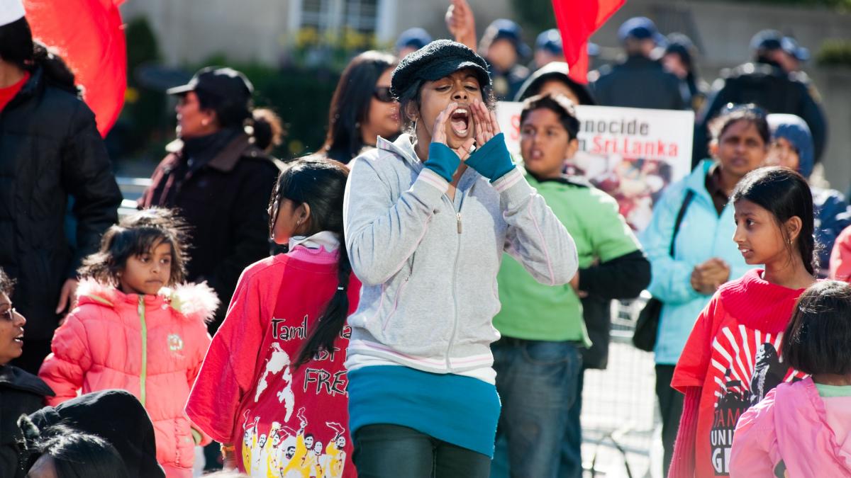 photo of young women shouting in crowd