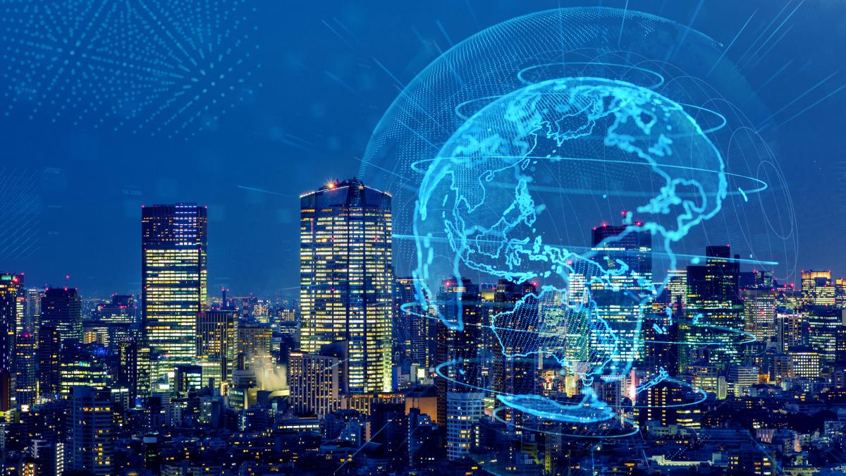 graphic image of globe over a photo of a city skyline at night