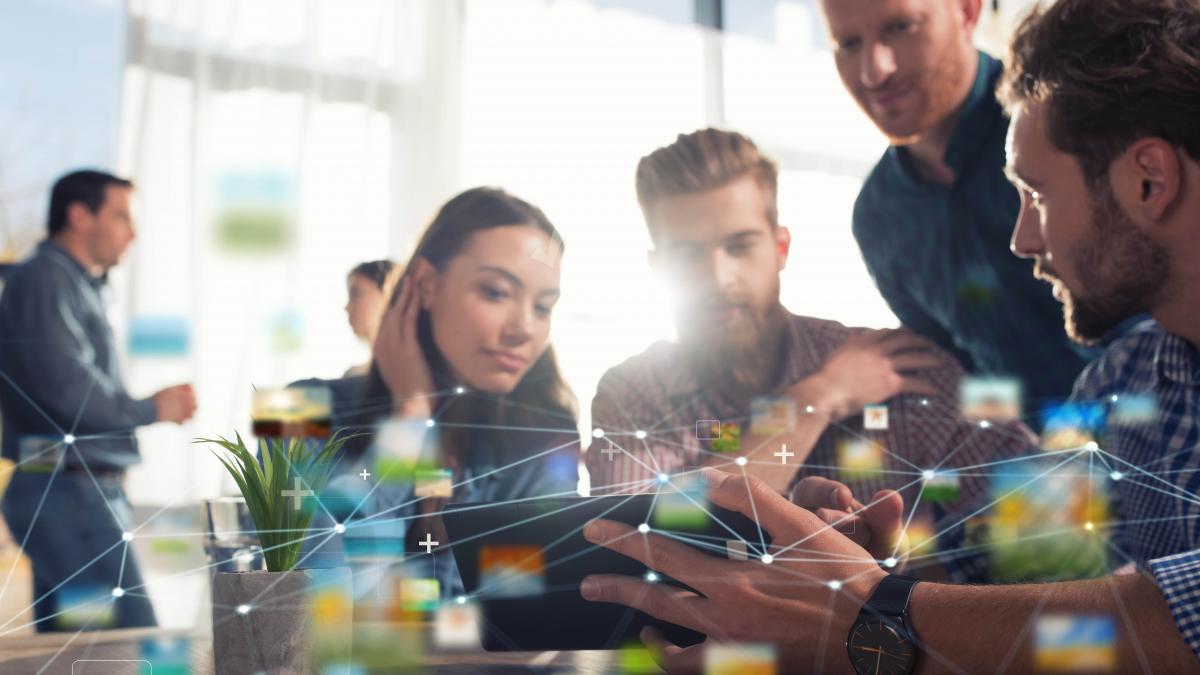 photo of young people at a word desk, with lights and dots connecting overlaid as a graphic 